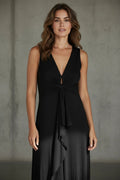 Model wearing a black Nu-Nv Clothing Gianfranco Ferre Studio sleeveless V-neck evening gown with front knot detail.