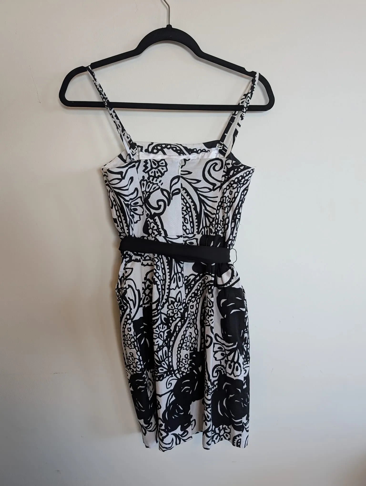 Nu-Nv Clothing black and white floral print mini dress with square neckline, spaghetti straps, and black waist tie.