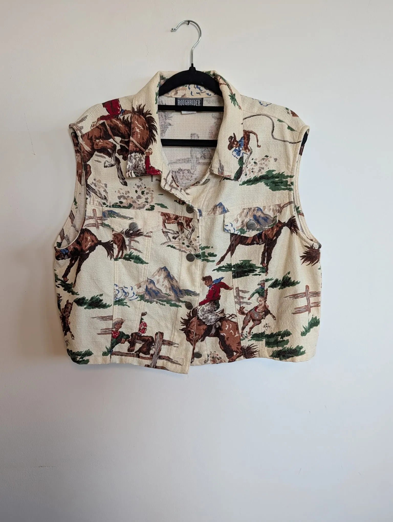 Nu-Nv Clothing vintage-inspired western print sleeveless button-down vest with cowboy and horse scene on cream fabric.